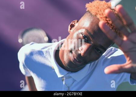 Portrait of young man on tennis court Stock Photo