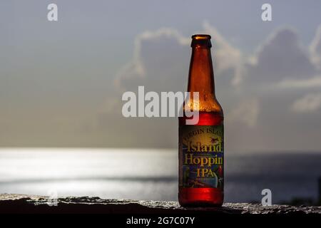 An ice cold Island Hoppin' IPA by St. John Brewers awaiting, with the glittering Caribbean Sea in the background equals a spectacular vacation. Stock Photo