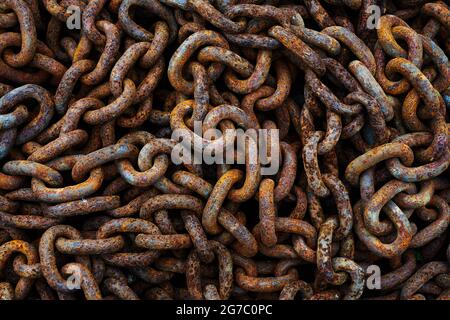 A pile of rusty chains as a dark textured background Stock Photo