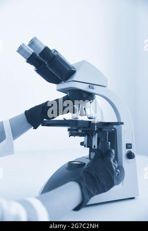 medical laboratory, scientist hands using microscope for chemistry, biology test samples, examining liquid, Doctor equipment, Scientific and Stock Photo