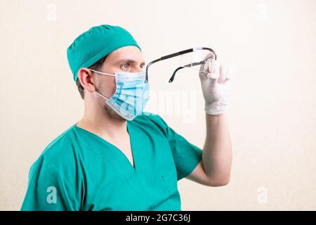 Doctor with goggles in his hands Stock Photo