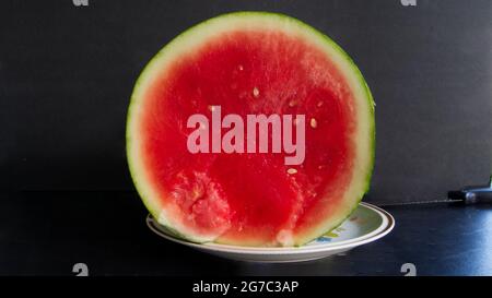 A Sliced Watermelon on a Glass Plate Stock Photo
