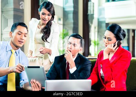 Asian businesspeople having a meeting Stock Photo