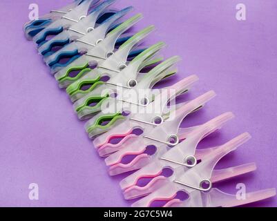 Washing pegs on purple background with copy space Stock Photo