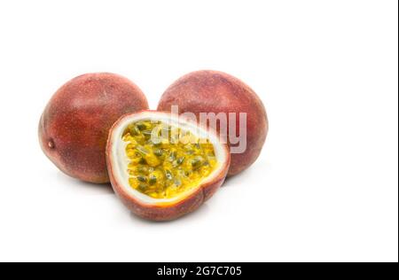Passion fruit in group display, one sliced passion fruit is put together with two whole fruit, image one white background, close up to see details. Stock Photo