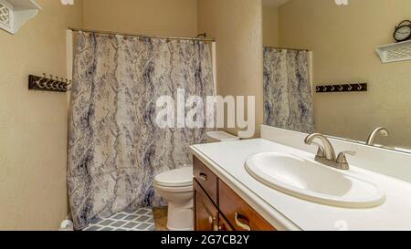 Pano Residential bathroom design ideas with tile floor and printed shower curtain Stock Photo