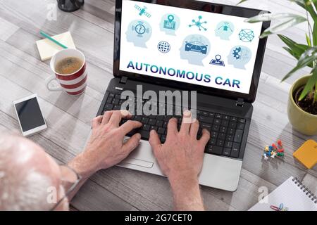 Autonomous car concept shown on a laptop used by a man Stock Photo
