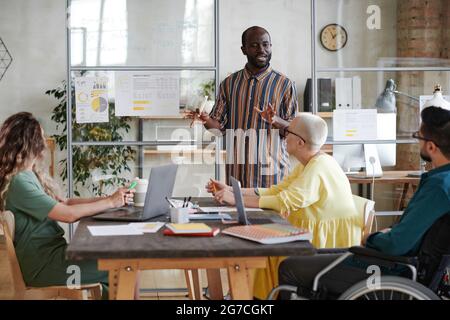 African businessman holding business presentation for his partners, he telling about financial business strategy Stock Photo