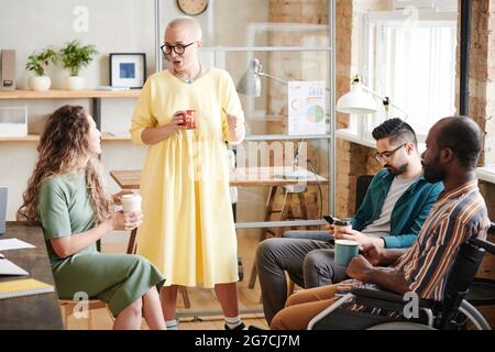 Group of business people sitting in circle and planning work together in team during meeting at office Stock Photo