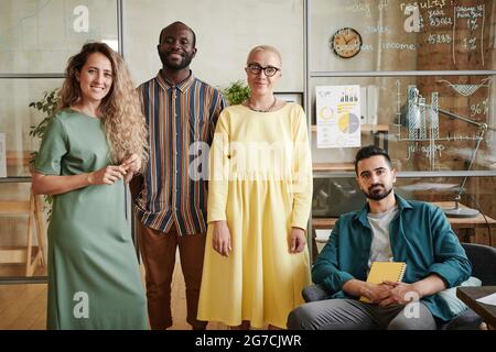 Portrait of successful business team of designers looking at camera while working at office Stock Photo
