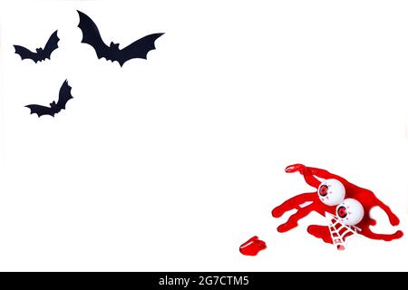 Halloween background made with paper bats and blood with scary eyes isolated on white.Copy space template. Stock Photo