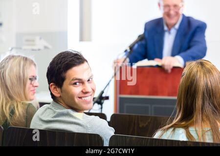 Students listening to college professor giving lecture Stock Photo