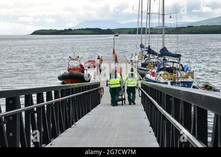 Bantry, West Cork, Ireland. 12th July 2021. Woman injured herself as she was walking by the Zetland pier and slipped by rocks, Bantry lifeboat rescue helped her get on the shore, Irish Air ambulance was also on the scene. Credit: Karlis Dzjamko/Alamy Live News Stock Photo