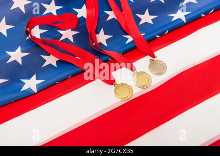 high angle view of golden medals on american flag Stock Photo