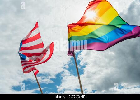 American and lgbt flags against blue sky with clouds Stock Photo - Alamy