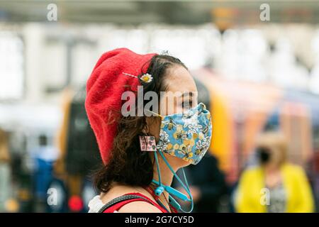 WATERLOO LONDON  13 July 2021.  A traveler at  Waterloo station wearing a facemask a day after Prime Minister’s Boris Johnson held  a TV press conference at Downing Street on the government’s decision to unlocking  Covid-19 restrictions on 19 July 2021  known as Freedom Day. The government has issued guidance  on wearing face masks, social distancing  and working from home and wearing facemasks will be a personal choice and no longer mandatory.  Credit amer ghazzal/Alamy Live News Stock Photo