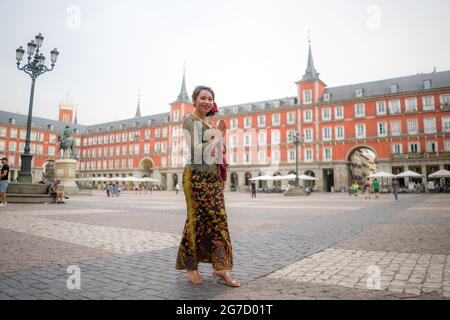 young happy and beautiful Asian woman wearing traditional Balinese kebaya dress - Indonesian girl in Bali clothes walking on street during holidays tr Stock Photo