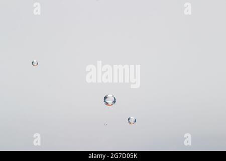 CO2 bubbles in mineral water attached to glass Stock Photo