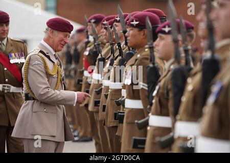 The Prince of Wales, Colonel on Chief, inspects the front rank of representatives from 1st, 2nd and 3rd Battalions of the Parachute Regiment during a ceremony to present new colours to the Regiment at Merville Barracks in Colchester. Picture date: Tuesday July 13, 2021. Stock Photo