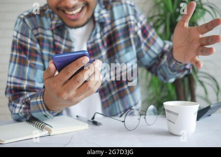 happy young man hand using smart phone. Stock Photo
