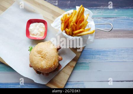top view of beef burger and chips on table with copy space  Stock Photo