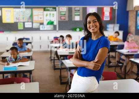 Portrait of african american female teacher smiling in the class at school Stock Photo