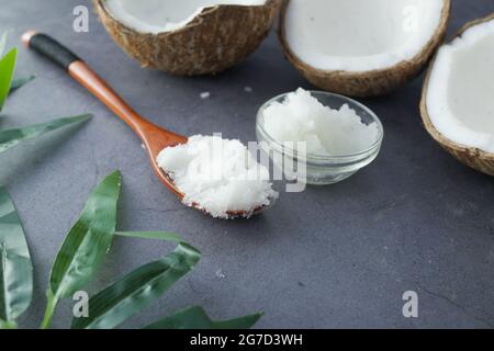 spoon with coconut oil and nut on black background  Stock Photo