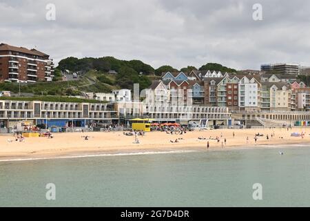 Boscombe, Bournemouth, Dorset, UK, 13th July 2021, UK Weather: Warm and sunny on the south coast as summer begins to make a return. People are on the beach at the start of what is expected to become a long dry and possibly hot spell of weather. Credit: Paul Biggins/Alamy Live News Stock Photo