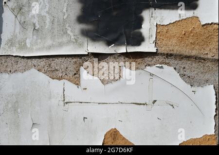 abstract grunge background texture, old weathered poster wall with ripped paper on a pressboard, copy space Stock Photo