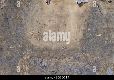 old weathered poster wall from pressboard with rests of ripped paper, abstract grunge background texture, copy space Stock Photo