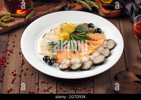 Assorted smoked fish platter on wooden background Stock Photo