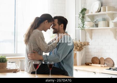 Lovely couple in love touch foreheads enjoy dating with wine Stock Photo