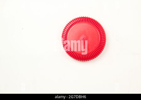 Red colour bottle cap on isolated white surface Stock Photo