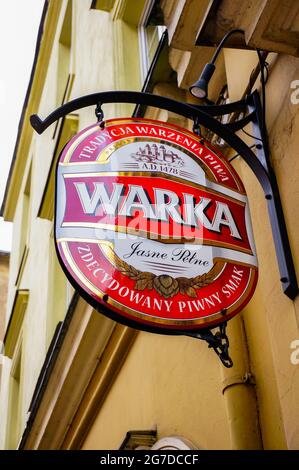 POZNAN, POLAND - Apr 13, 2016: A Warka beer brand board on a wall in the city Stock Photo