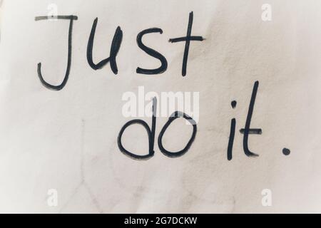 Motivational word written on paper(just do it) Stock Photo