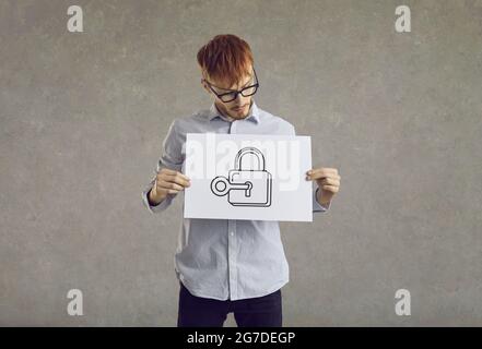 Man holding picture of key opening door lock and getting access to business secret Stock Photo