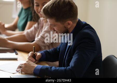 Intern, office employee writing notes on corporate training Stock Photo