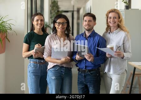 Happy multiethnic different aged business team posing in office Stock Photo