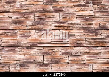 Brown stone wall texture, uneven surface, grunge brick background, abstract pattern, rocks surface, rough granite. Buildings facade. Textured backdrop Stock Photo
