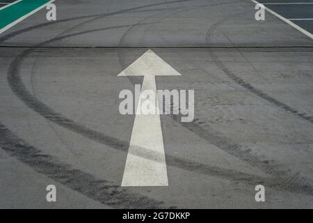 White arrow on an empty parking lot Stock Photo