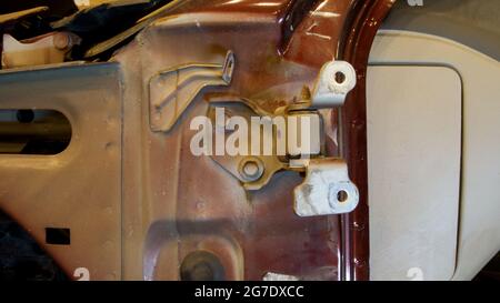 A Close Up of a Door Hinge on a Car Missing the Door Stock Photo
