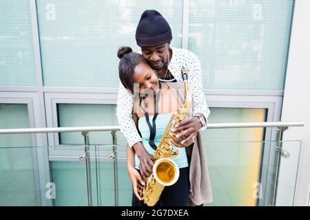 African couple playing Saxophone Stock Photo