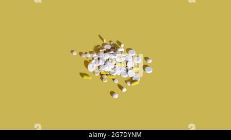 Pile of assorted capsules and pills on yellow background. Health and pharmaceutical industry concept Stock Photo