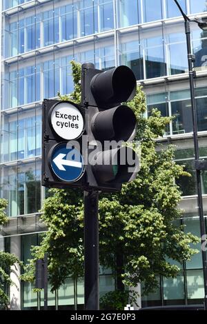 Green light on traffic lights with a left right of way excluding cycles on a street in London Stock Photo