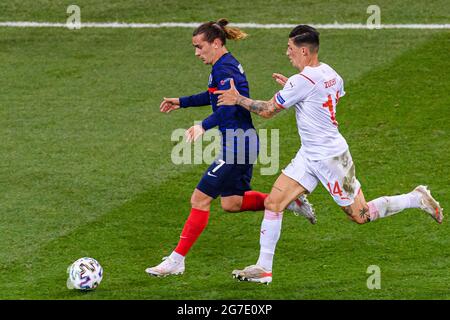 Bucharest, Romania - 28, June: Antoine Griezmann of France (L) is chased by Steven Zuber of Switzerland (R) during the UEFA Euro 2020 Championship Rou Stock Photo