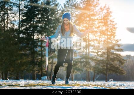 Woman walking thru slushy snow on a meadow Stock Photo