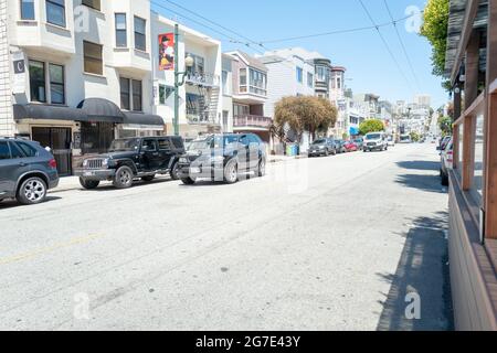 Vehicles are parked alongside a road in Lower Pacific Heights, San Francisco, California, June 14, 2021. () Stock Photo