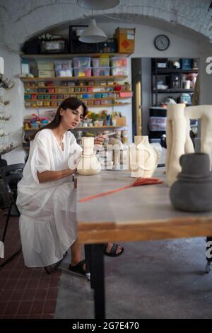 A woman making pottery during her pottery class Stock Photo