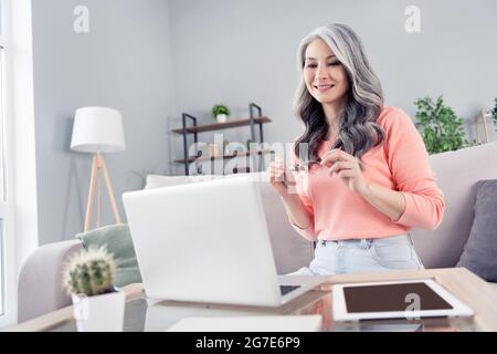 Portrait of attractive skilled cheerful middle-aged woman working remotely career project at home house flat indoor Stock Photo
