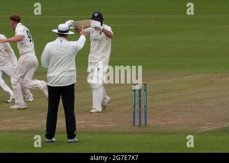 Chester le Street, England, 13 July 2021. Ned Eckersley of Durham Cricket holding his bat in the air after being given out LBW by umpire Neil Pratt during their county championship match against Nottinghamshire at the Riverside Ground Chester le Street. Credit: Colin Edwards/Alamy Live News. Stock Photo